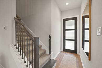 The entry has a beautifully stained 8-foot wood do