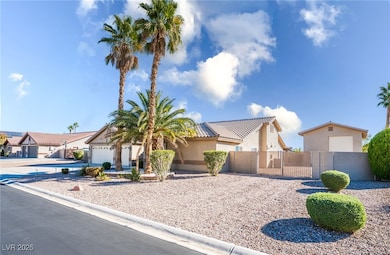Mediterranean / spanish house with stucco siding, a gate, concrete driveway, an attached garage, and a residential view