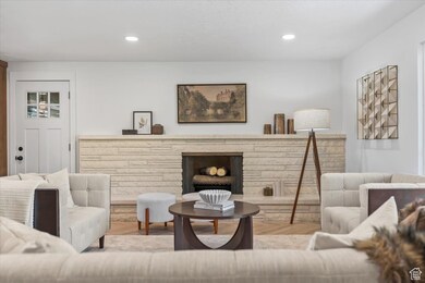Sitting room with recessed lighting, wood finished floors, and a fireplace