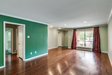 Spare room featuring crown molding and dark hardwo