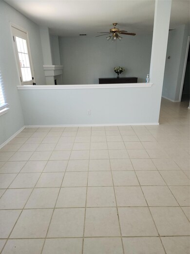 Spare room featuring a fireplace, tile patterned 