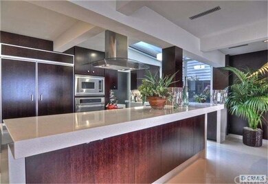 The well-designed kitchen features a walk-in pantr