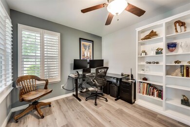 Office with ceiling fan and light wood-type floori