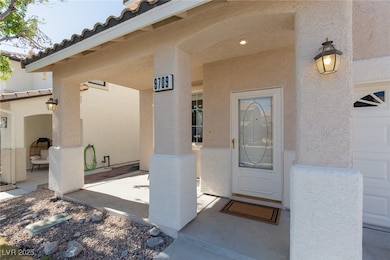 View of exterior entry with stucco siding and a ti