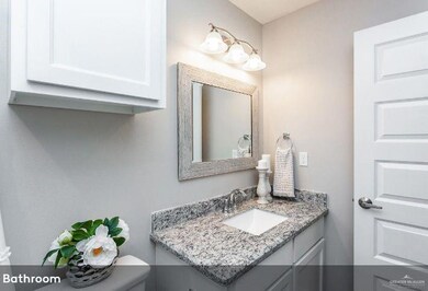 Half bathroom with vanity and toilet