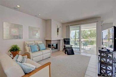 Living room overlooks the patio and ocean and tree