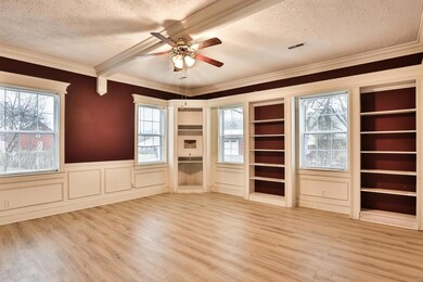 LIving Room with crown molding, built in shelves, 