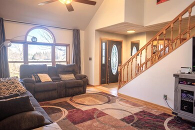 Living area with high vaulted ceiling, baseboards,