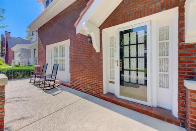 An expansive front porch welcomes you to this impr
