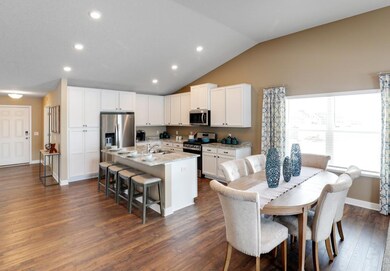 Here a great view of the open concept and vaulted ceiling at work! Model photo, colors and selections may vary.