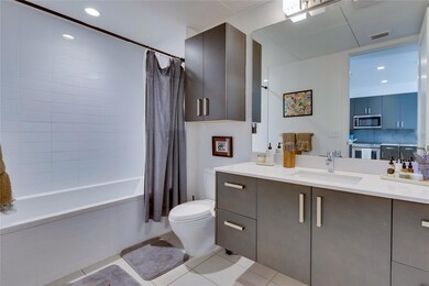 Bathroom with vanity, tiled shower / bath combo, 