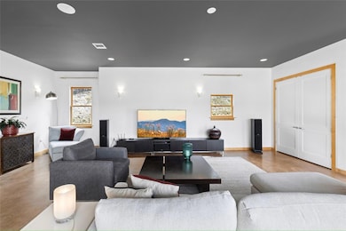 Living room with baseboards, recessed lighting, a