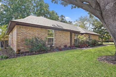 Mature landscaping wraps the home in color and serenity.