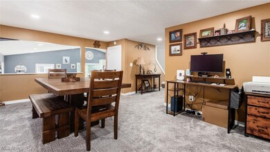 Dining area featuring light colored carpet, an office area, and recessed lighting