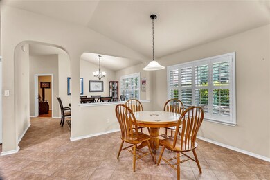 Dining space featuring lofted ceiling, a chandeli