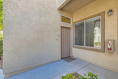 Entrance to property with a patio area and stucco
