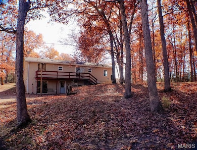 Rear view of property with a deck