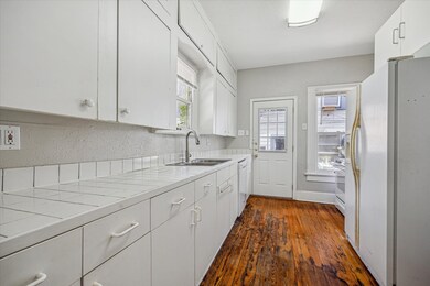 The view of the kitchen with tile countertops and