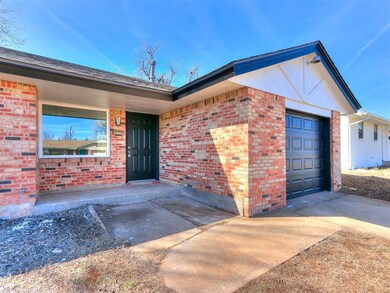 Entrance to property with a garage, concrete drive