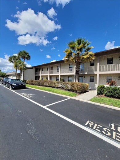 Front of building, unit on 2nd floor behind tree.