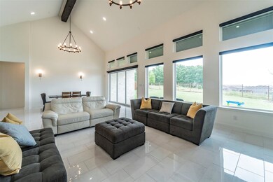 Living room featuring a chandelier, a healthy amou