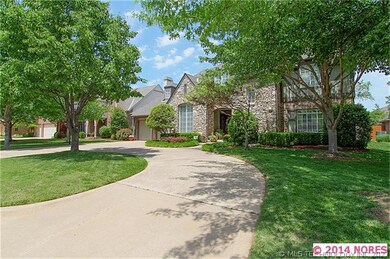 Circular drive and mature trees grace the front en