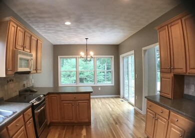 dining area with sliders, hardwood flooring