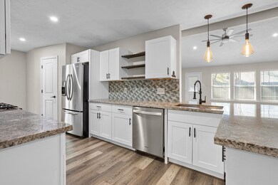 Galley kitchen with stainless appliances and granite countertops
