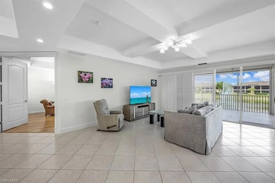 Living room with a ceiling fan, recessed lighting,