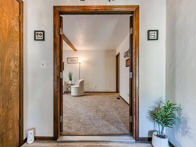 Hallway featuring carpet floors and a textured cei