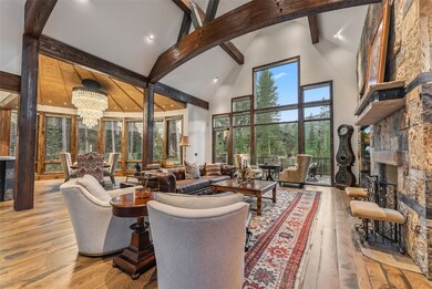 Living room featuring high vaulted ceiling, beamed