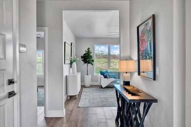 Entrance foyer with wood finished floors and radiator