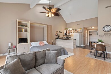 Bedroom with wood-type flooring, beamed ceiling, w