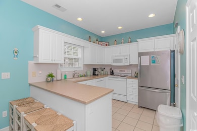 Kitchen with light tile patterned flooring, visibl