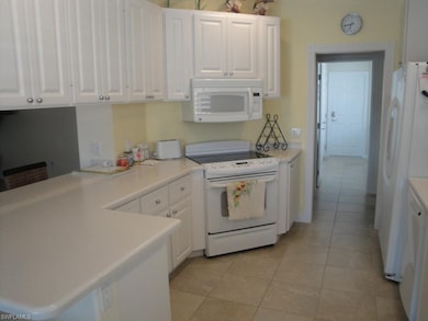 Fully equipped kitchen with Corian counter-tops.