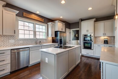 Natural light fills the kitchen over the window and through the back windows. 