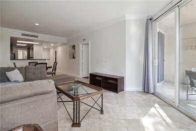 Living area featuring crown molding, baseboards, a