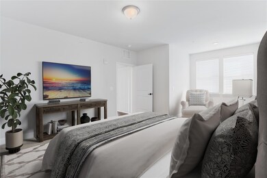 The bedroom has huge windows over the sitting area