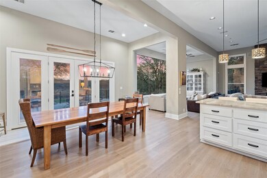 Dining area with a chandelier, light wood-style f
