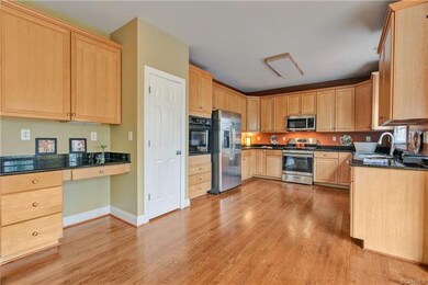 Computer desk in kitchen.
