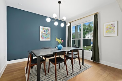 Dining space with baseboards and wood finished fl