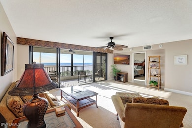 Carpeted living room featuring a textured ceiling