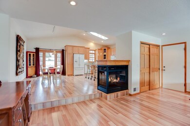 Cozy 3 sided gas fireplace between the kitchen and