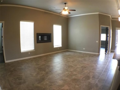Unfurnished room featuring a ceiling fan, baseboards, and ornamental molding