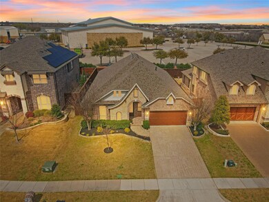 View of front of home with an attached garage, a r
