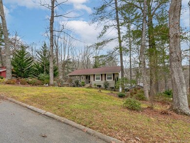 Gently sloping lot with mature landscaping and gar