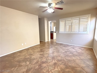 Unfurnished room featuring a ceiling fan and baseb