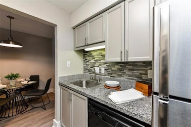 Kitchen featuring hanging light fixtures, stainles