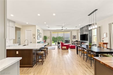 Kitchen featuring a sink, light wood finished floo