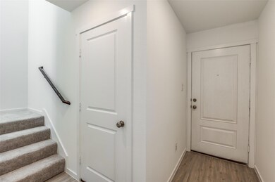 Doorway with light hardwood / wood-style floors